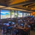 tables inside restaurant with distant ocean view